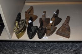 Eight antique flat irons.