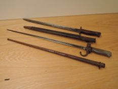 A French Lebel Epee Bayonet 1886 pattern, blade length 51cm, overall length 63cm, with scabbard