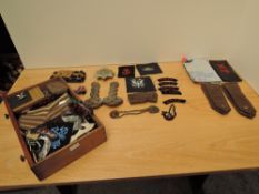 A collection of Military Badges, Buttons and Cloth Badges including Kings Own Belt & Buckle, white