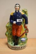 A reproduction Staffordshire pottery flatback Napoleon ornament, measuring 32cm tall