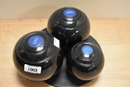Three weighted plastic carpet bowls.