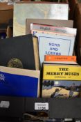 A small carton of books including titles such as Hadrian's Wall by Stephen Johnson, Daniel Defoe's
