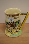 A Crown Devon 'Widdicombe Fair' relief moulded tankard, measuring 15cm tall