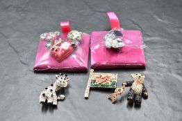 Five Wilson & Butler brooches including Welsh flag, Giraffe, Pink Ribbon panda, etc