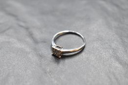 A four stone princess cut diamond ring, total approx 0.37ct in a four claw collared basket mount