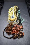 Ten strings of vintage beads including carnelian, tigers eye, opaque glass, jadeite, etc