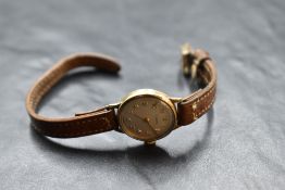 A lady's 9ct gold wrist watch by Tissot having Arabic numeral dial to champagne face in plain case