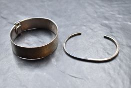 A plaited silver cuff bracelet having concealed clasp and a silver tension bangle