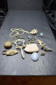 A vintage jewellery box containing a selection of jewellery including brooches, rolled gold