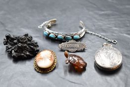 A small selection of vintage jewellery including black mourning brooch, silver locket having