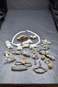 A small selection of diamante jewellery, bakelite buckle and white ceramic floral style necklace