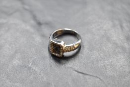 A 750 grade white metal diamond set signet ring, the rectangular platform set with baguette diamonds