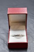 A diamond set platinum wedding band having five inset diamonds, total approx 0.2ct, size M &