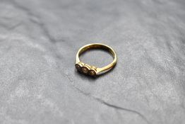 A diamond trilogy ring in an illusionary setting on a yellow metal loop stamped 18ct & plat, size