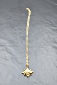 A Victorian yellow metal pendant stamped 9ct having central diamond chip in moulded mount with