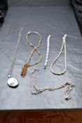 Four silver necklaces including an oval locket and Baltic Amber, and an enamelled bracelet
