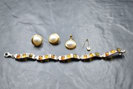 A Polish silver articulated bracelet having five Baltic amber set panels, and a simulated split