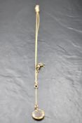 A yellow metal necklace of Albertina style having tassel and hair locket fobs, no marks, presumed