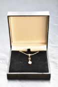 A 9ct gold opal pendant of Art Deco style having drop to second opal, with fixed 16' chain, approx
