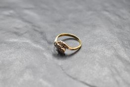 A diamond chip trio ring having crossover shoulders on a yellow metal loop stamped 18ct, size O &