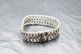 A heavy plaited Mexican silver bracelet having concealed clasp, approx 180mm & 52g