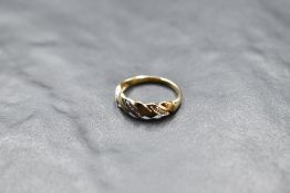 A 9ct white and yellow gold moulded band ring having three inset diamond chips, size L & approx 1.