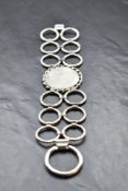 A 1970's HM silver bracelet of stylised form having concealed clasp and bearing makers mark PW,