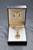 An Edwardian 9ct rose gold pendant of tear drop form set with amethysts and seed pearls on a later