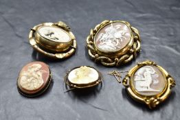 Four conch shell cameo brooches depicting different scenes including George & the dragon, Flora,