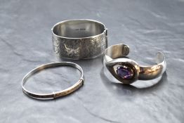 Three silver bangles including Mexican cuff, Christening style and hinged bracelet with engraved
