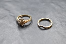 A diamond triple cluster ring with diamond set moulded shoulders, total approx 0.25ct on a 9ct