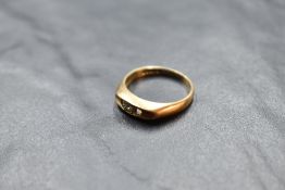 A 9ct rose gold ring having a central diamond, approx 0.05ct in an open boat form mount on 9ct