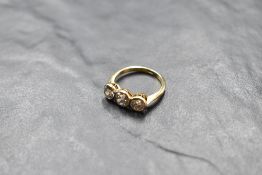 A diamond trilogy ring, total approx 1.75ct, all three old cut diamonds in collared mounts on a