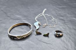 A silver and faux opal four piece jewellery suite comprising of pendant, earrings, ring and