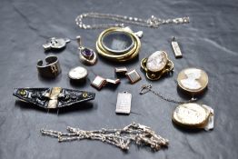 A small selection of vintage costume jewellery including cameo brooches, pinchbeck hair locket