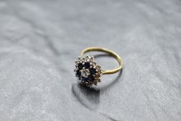 A sapphire and diamond triple daisy cluster ring having central brilliant cut diamond approx 0.