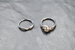 A diamond ring having a central diamond with a trio of diamond chips to each side, total 0.50ct on