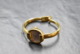 A lady's Gucci gold plated bangle watch no: 0027991, having plain white face