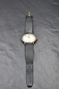 A gent's 1970's 9ct gold manual wrist watch by Garrard having Arabic numeral dial in a gold case