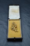A 15ct gold and seed pearl brooch modelled as a tied sprig of flowers, approx 8.7g