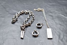 A pair of silver hoop earrings bearing oversized millennium hallmarks, a silver ingot pendant and