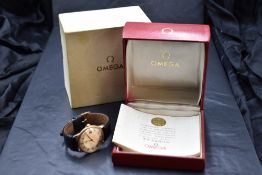 A gent's 1960's 9ct gold manual wrist watch by Omega, no: 20639715, having baton numeral dial with