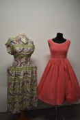 A 1940s paisley cotton day dress, having button down front and triangular turn overs to pockets