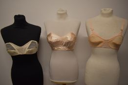 Two 1950s strapless boned bullet bras and a sheer 1950s nylon bra.