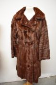 A vintage mid century squirrel fur coat, having monogramed emerald green lining.