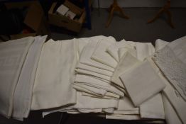 A selection of predominantly damask vintage table cloths, napkins and tray cloths.