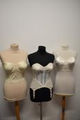 A 1950s strapless boned corselette/ girdle, having lace to cups and 4 suspender clasps, a 1950s