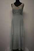 A pale blue silk 1930s bias cut nightdress, having embroidered rose buds and floral sprigs to