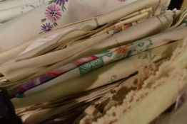 A large assortment of vintage table linen, including table cloths, napkins and tray cloths.