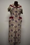 A vibrant 1490s crepe day dress, having bright cerise accents to shawl collar, pockets and cuffs,